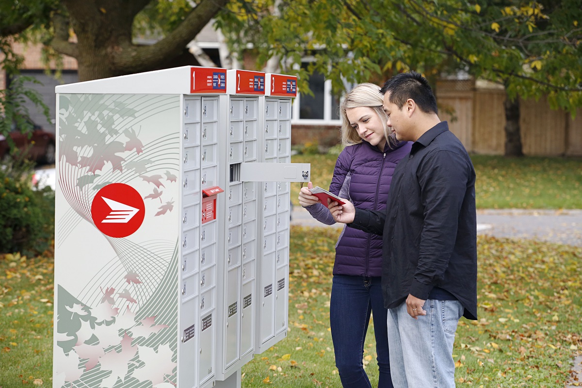 Canadians collect mail from Canada Post community mailbox