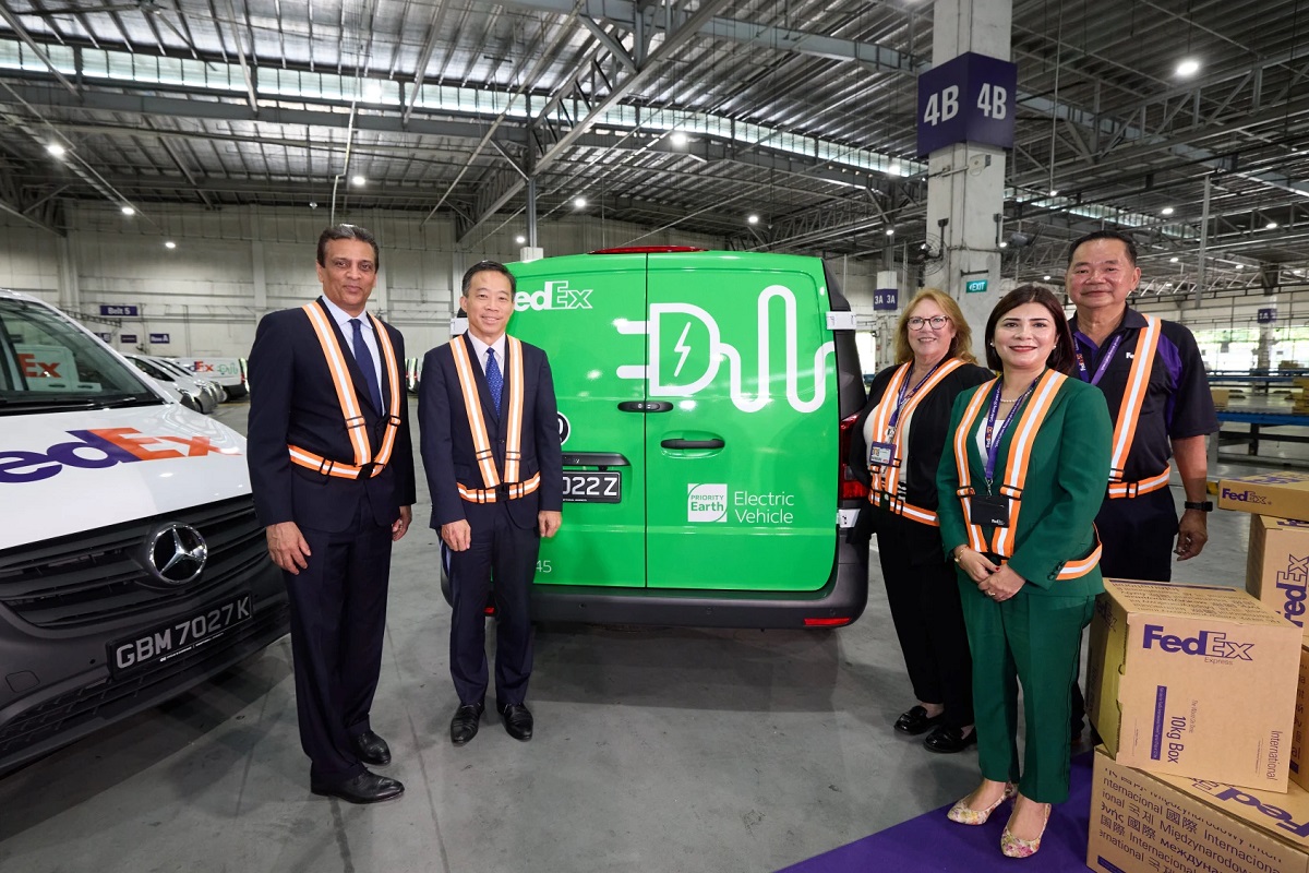 FedEx executives with the new electric vans