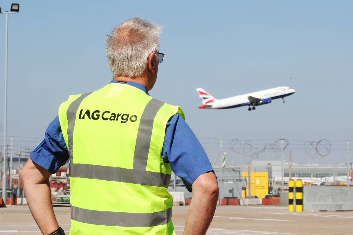 IAG Cargo employee watches plane take off